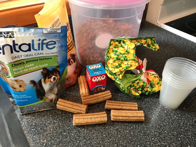 Ingredients we chose to use. Beef stock cubes, peas&corn, dog nuts and treats.
Plastic cups to set in or you could use ice trays for small pupsicles or if you have the actual plastic ice block containers go for that.