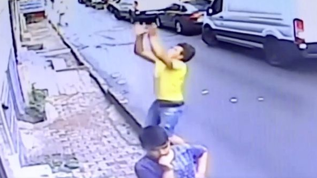 Watch the shocking moment a baby falling from window is caught by boy walking by