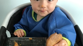Try it Out Tuesday - Estelle tries out a raincoat bib on her baby