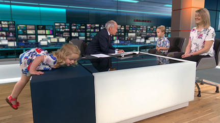 Adorable toddler upstages news anchor in the most hilarious way